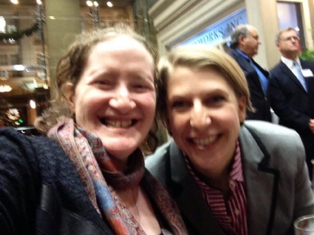 Rhonda with smiling colleague at community event.