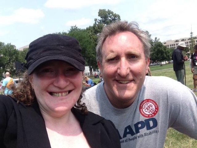 Rhonda with Andy Imparato, smiling at rally.