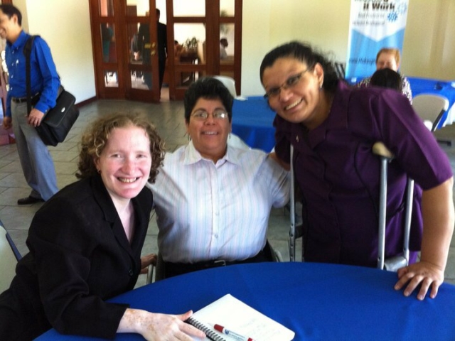 3 smiling women with disabilities gathered to work on the Making it Work Central American projects.