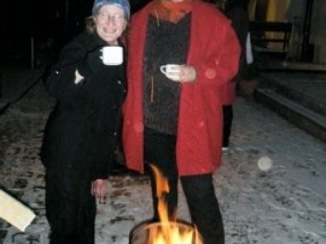 With colleague from HI- Belgium in front of a fire.