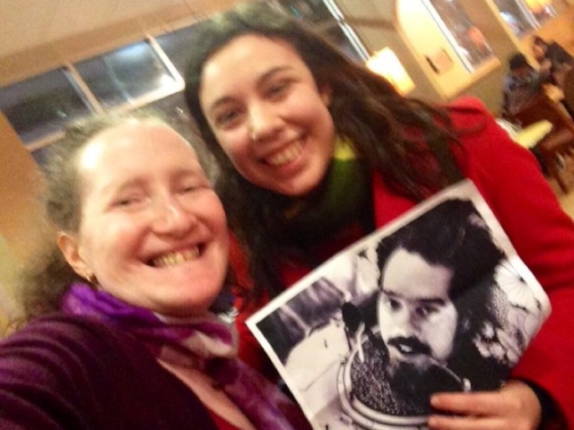 Rhonda with colleague holding photo in honor of disability rights pioneer Ed Roberts.