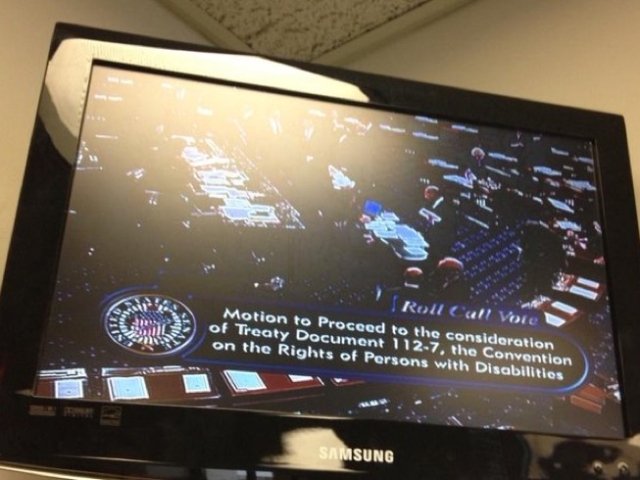 Image of a television with CSPAN's coverage of the CRPD motion to proceed being heard on the Senate floor