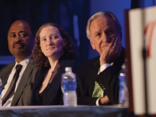 Senator Harkin and Rhonda looking pensive listening to a speech on the podium of the Leadership Conference on Civil and Human Rights Gala, 2014.