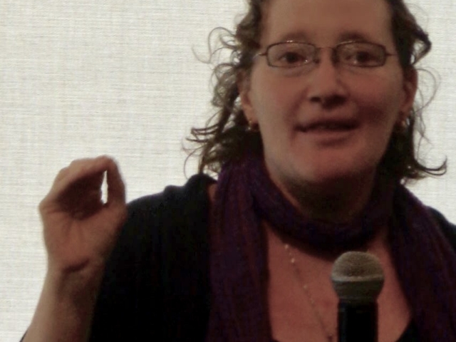 Rhonda presenting (with microphone in hand) at Gallaudet University, 2013