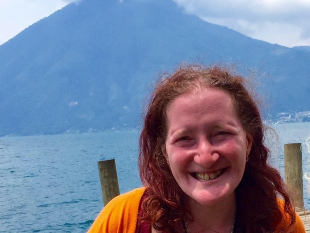 Rhonda smiling in front of a volcano on Lake Atitlan, Guatemala.