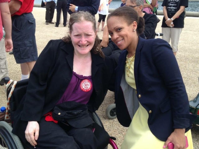 Rhonda with disability liaison for the Obama Administration at a CRPD rally. Rhonda wears CRPD sticker.
