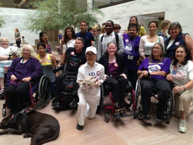 A group of about 20 disability advocates with and without disabilities at the Senate Hart building, 2013