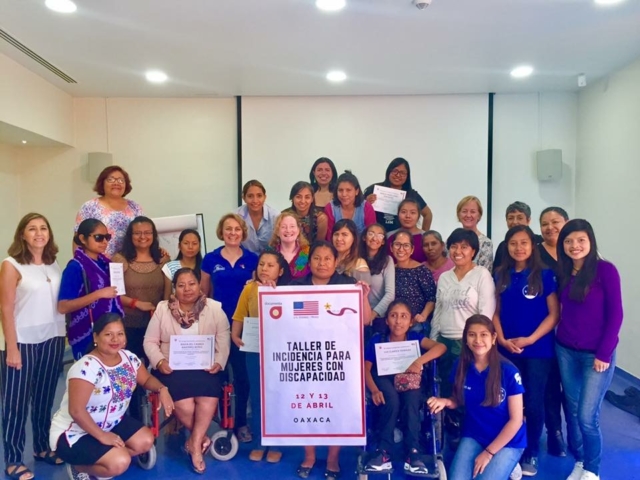 Group of women with disabilites, U.S. Embassy staff and Documenta staff following training.