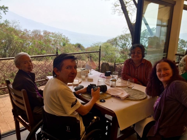 Rhonda sitting at a table with a view of the mountains