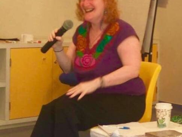 Rhonda laughing with microphone in hand, Oxaca, Mexico.