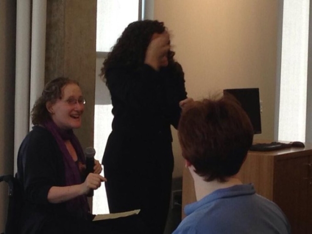 Rhonda speaking to group of students at Gallaudet University. Sign language interpreter interprets.