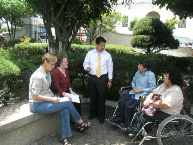 Rhonda and 3 other colleagues meeting and taking notes in park in Guatemala.