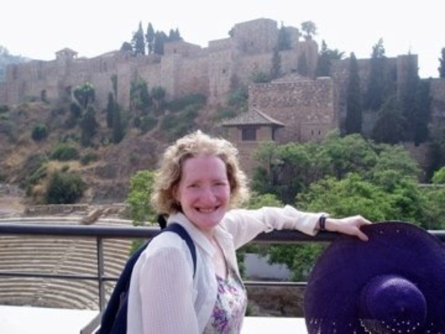 Rhonda in front of a colliseum and ruins in Spain.