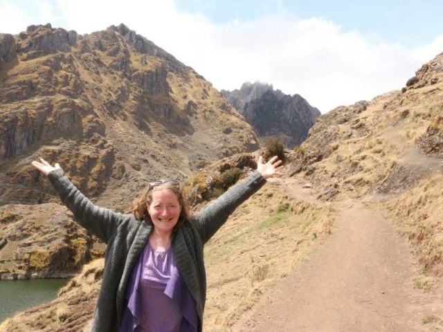 Rhonda in the mountains of Peru- arms in the air.