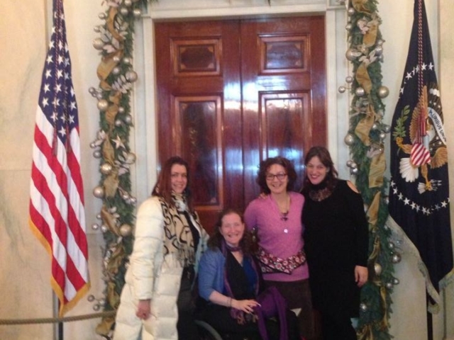 Rhonda with colleagues in the White House, US flags and seal visible.