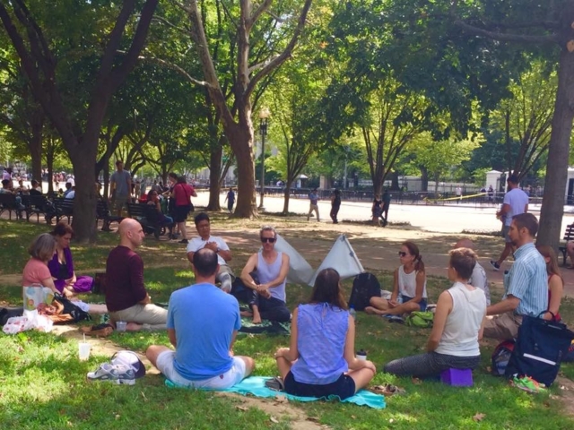 A circle of advocates meditating for peace in Laffayette Park (in front of the White House), 2017.