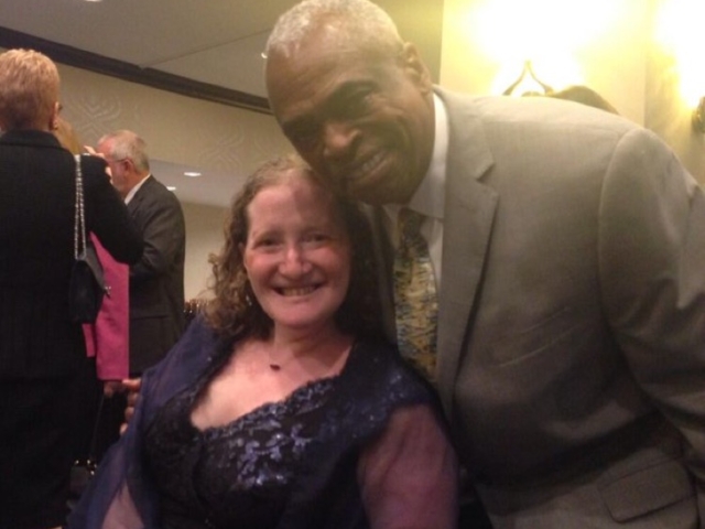 Rhonda with Wade Henderson of LCCHR smiling at camera at reception.