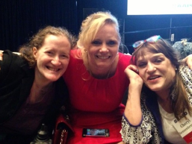 Rhonda with 2 other disability colleagues, smiling at camera.