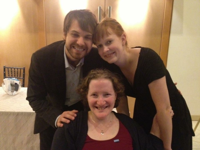 Rhonda sitting in wheelchair with colleagues at French Embassy