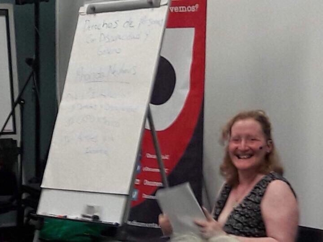 Rhonda presenting with a smile in Mexico, 2018 (Easel with training notes in Spanish behind her).