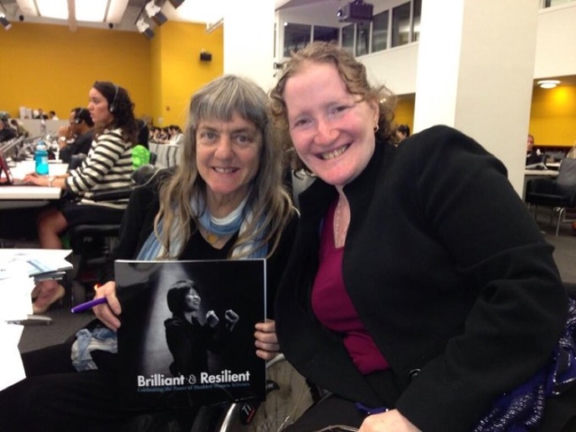 Rhonda with Susan Sygall of MIUSA at the UN. Susan holds a book titled "Brilliant and Resilient".