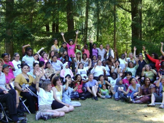 Large excited group group of *WILD* women with disabilities from around the world at MIUSA's Gender, Disability and Development Institute in the woods of Oregon.