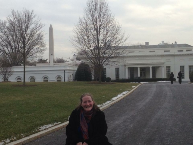 Rhonda sitting in her wheelchair in front of the west wing entrance of the White House.