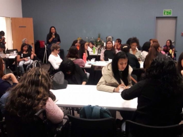 Women with disabilites doing group work at training.