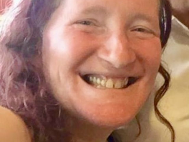 Rhonda with long hair grinning.