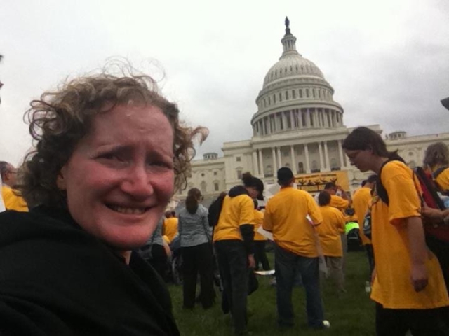 Rhonda in front of the US Capitol at aMedicaid Matters rally. With participants in yellow shirts.