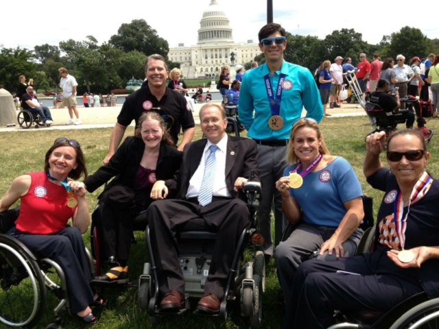 Rhonda with Congressman Jim Langevin and paraolympic athletes advocating for the CRPD, 2013