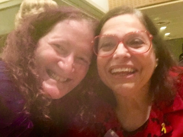 Judy Heumann and Rhonda smiling at camera.