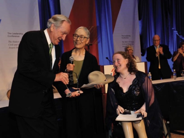 Senator Harkin receiving the LCCHR award. Presented by Yoshiko Dart and Rhonda. Yoshiko carries the hat of Justin Dart.